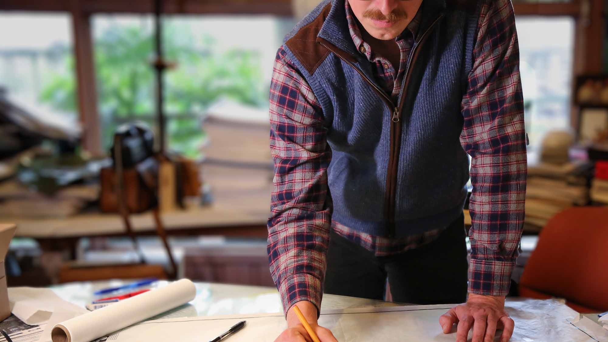 Architect wearing stylish Gordon Sportswear looking over building documents